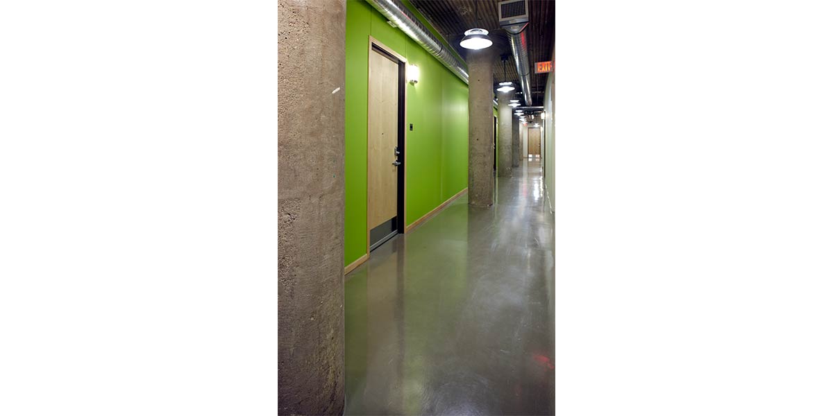 green hallway in renaissance box with entrance to unit