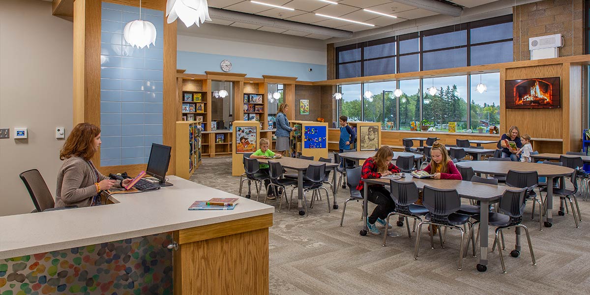 Media center with desk and tables with students