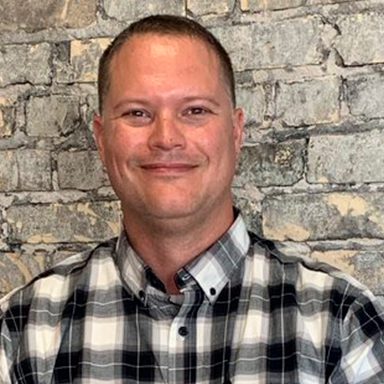 portrait of man in plaid black and white shirt