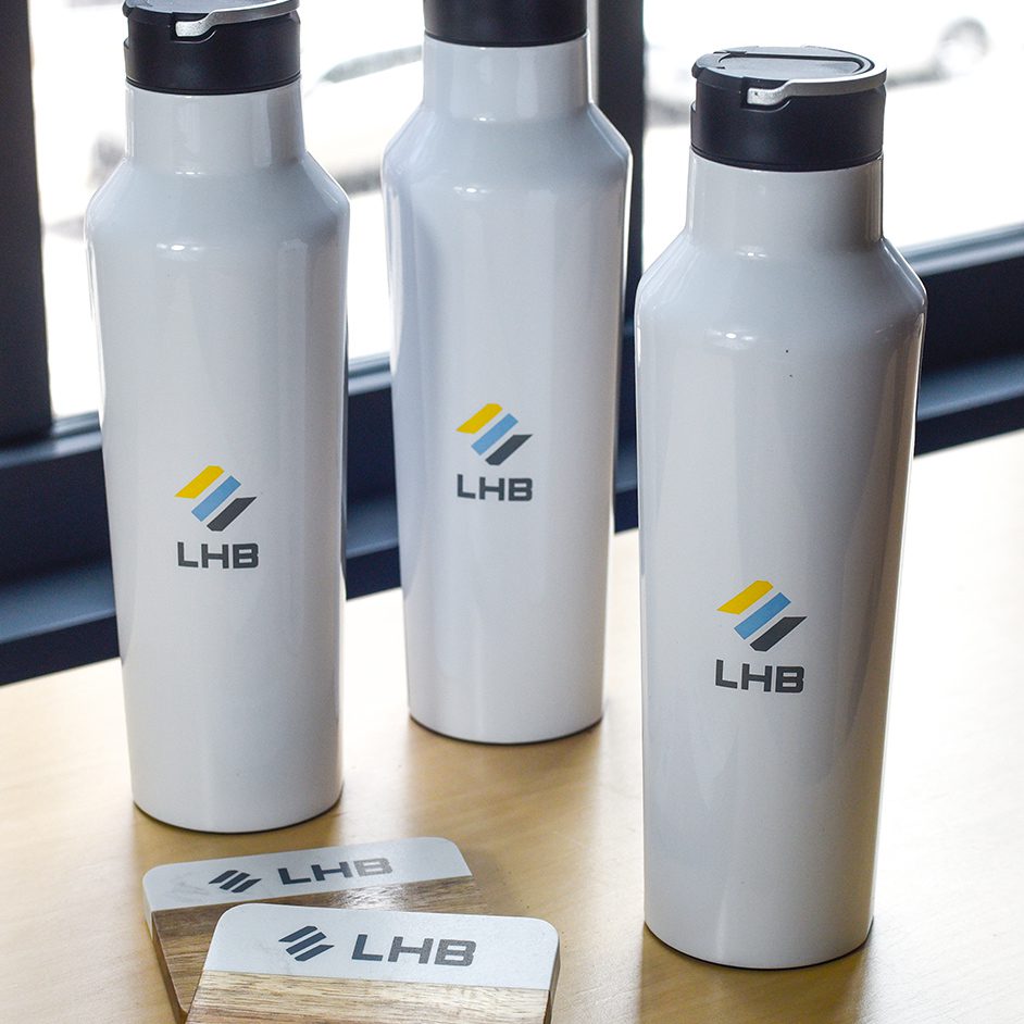 white bottles and coasters with LHB branding